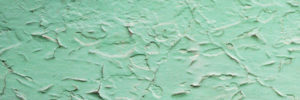 Textur einer abbröckelnden grünen Wand